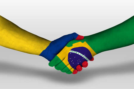 Handshake between brazil and columbia flags painted on hands, illustrationの写真素材