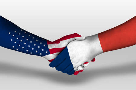 Handshake between france and united states of america flags painted on handsの写真素材