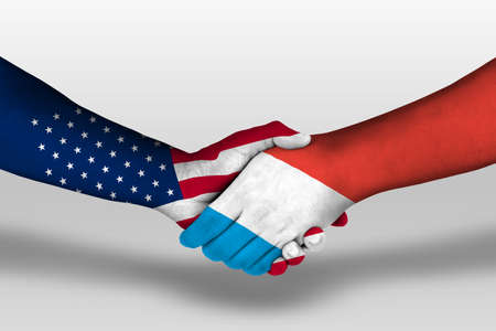 Handshake between luxembourg and united states of america flags painted on hands, illustrationの写真素材