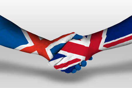 Handshake between united kingdom and iceland flags painted on hands, illustrationの写真素材