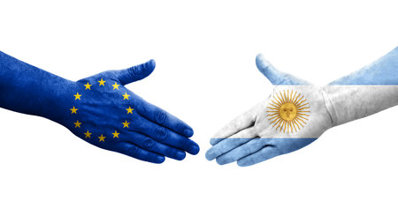Handshake between Argentina and European Union flags painted on hands, isolated transparent image.の写真素材