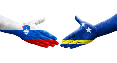 Handshake between Curacao and Slovenia flags painted on hands, isolated transparent image.の写真素材