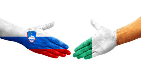 Handshake between Ireland and Slovenia flags painted on hands, isolated transparent image.の写真素材