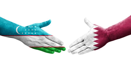 Handshake between Uzbekistan and Qatar flags painted on hands, isolated transparent image.の写真素材