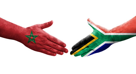 Handshake between South Africa and Morocco flags painted on hands, isolated transparent image.の写真素材