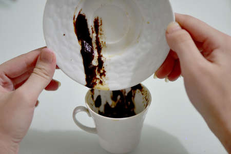 Turkish coffee cup, saucer and two hands, Turkish coffee fortune.の写真素材