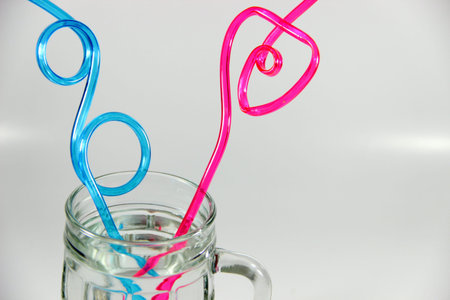 Glass with red and blue straw