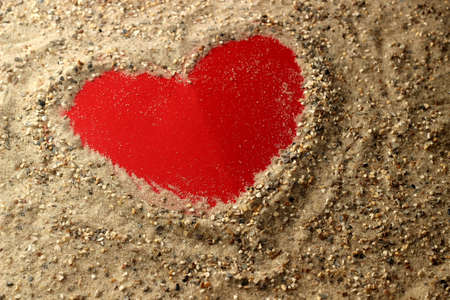 Red heart in the sandの写真素材