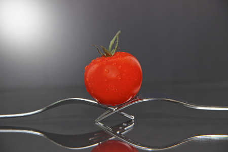 Tomato on forksの写真素材