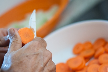 old man cut carrotsの写真素材