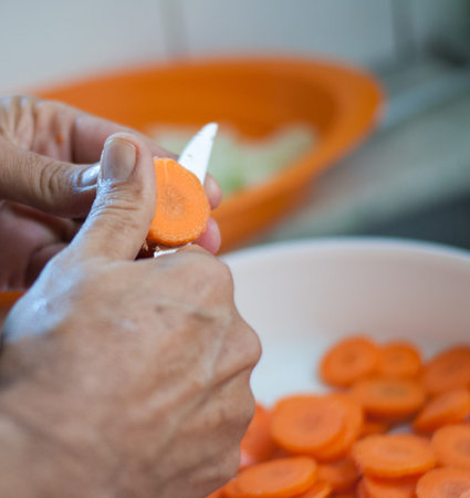old man cut carrots