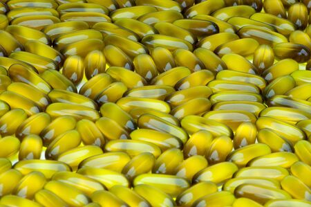 Closeup of group of soft gel capsules   avocado  backgroundの写真素材