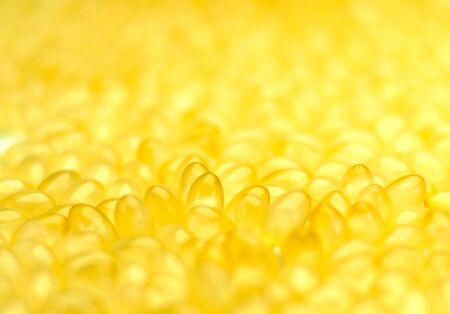 Background with a closeup of group of coconut oil capsules  Selective Focusの写真素材