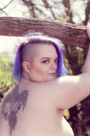 portrait of a purple haired woman outsideの写真素材