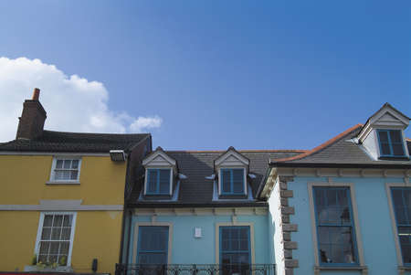 18th century roofline, windows and frontages in English market town, with blue sky space for text. Viewed from public location.の写真素材