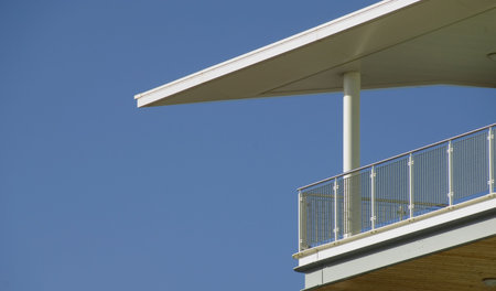 Dramatically shaped modern balcony against clear blue sky with plenty of copyspaceの写真素材