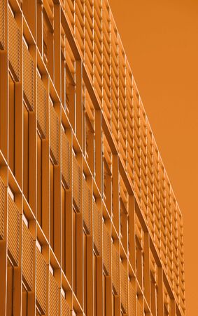 Background of orange-tinted corporate office building の写真素材