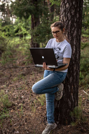 Girl on a walk on a bright sunny spring day in the bosom of natureの写真素材