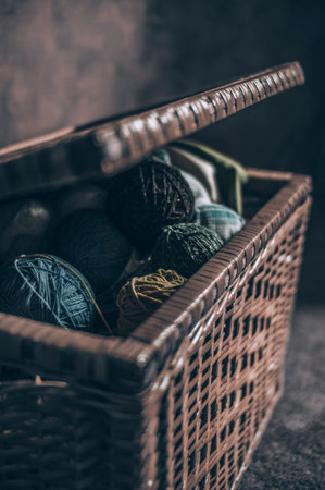 Wicker chest in retro style with balls of wool for knitting