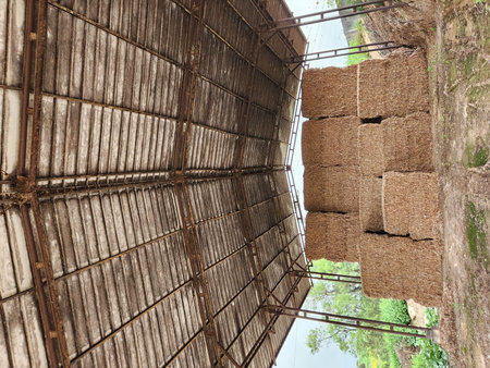stack of cubes of hay under a roof