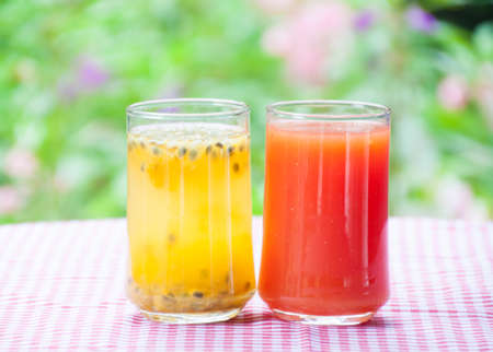 Smoothie papaya juice on table with garden flower backgroundの写真素材