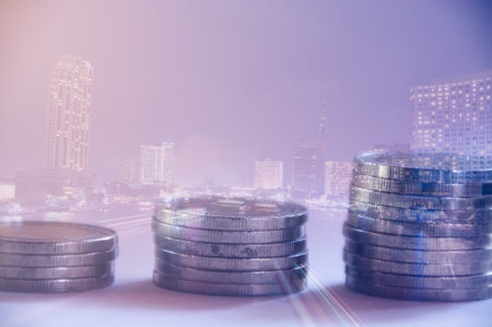 Rows of coins with city background, finance and banking concept