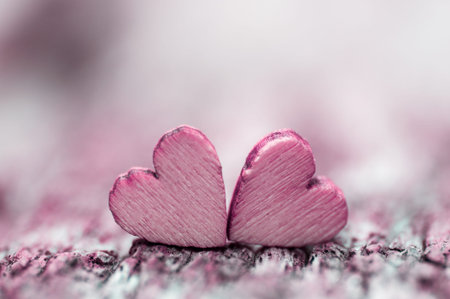 Two wood hearts on wooden tableの写真素材