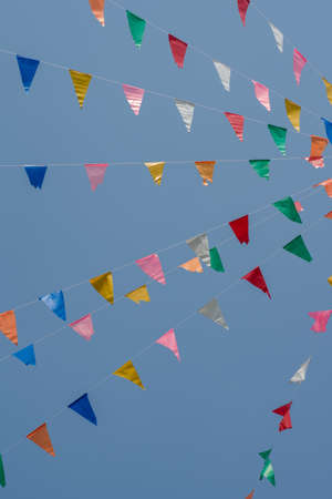 Colorful bunting flags with blue skyの写真素材