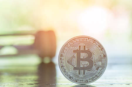 Bitcoin and hourglass with nature background, saving money conceptの写真素材