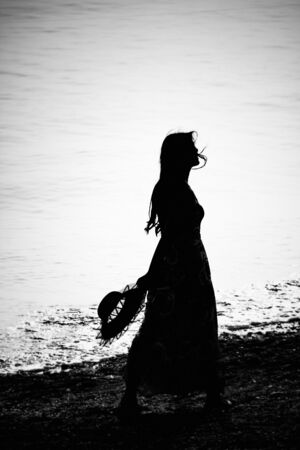 A lonely girl is at the seaside in Dalian, Liaoning Province, Chinaの写真素材