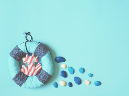 Lifebuoy and sea shells on a blue background. The concept of recreation at sea, safety, children at...