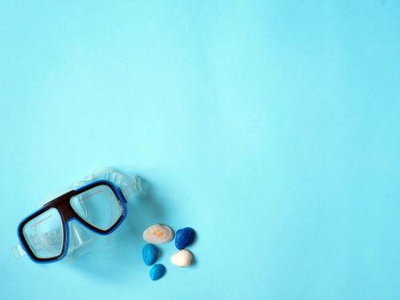 Underwater glasses and seashells on blue background.