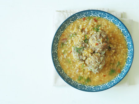 Turkish lentil soup, bulgur with vegetables and herbs on white background