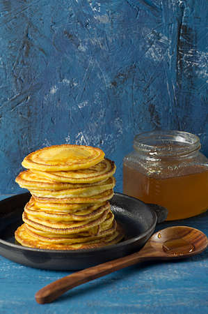 Frying pan of freshly baked pancakes, Ingredients and kitchenware for pancakes making.の写真素材