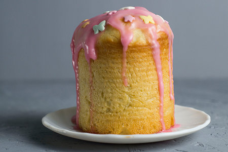 muffin with whipped cream, cake with icing on a plate