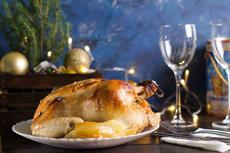 Christmas dinner. Fried chicken. Winter holiday table. Roast Turkey on a wooden background with a...