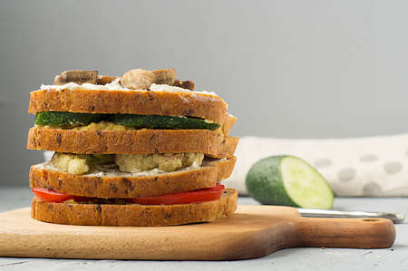 Vegetarian sandwich with tomato, mushrooms, cucumber, cauliflower and hummus. Healthy food, snack.の写真素材
