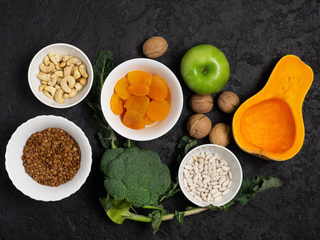 Food sources of potassium, magnesium on a dark background top view. Copy Space. Vegetables, nuts,...