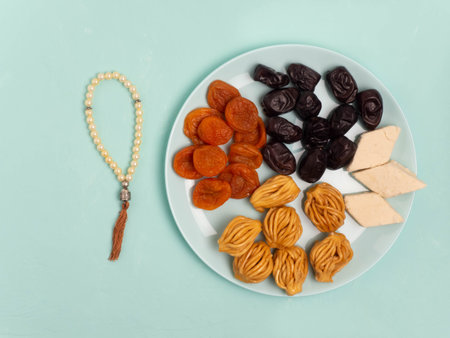 Flatley with rosaries, sweets, dates. The Concept Of Ramadan.