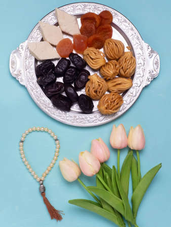 Flatley with rosaries, sweets, dates and tulips. The Concept Of Ramadan.の写真素材