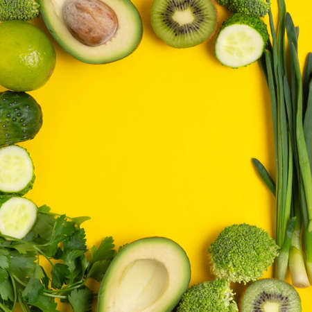 Various vegetables and fruits on a yellow background, top view, laid out in a circle. The concept of healthy eating, food background. Vegetable border with space for text. Vegan, vegetarian.の写真素材