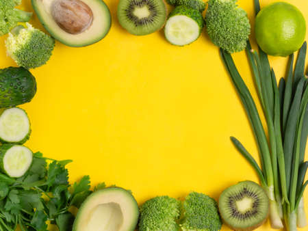 Various vegetables and fruits on a yellow background, top view, laid out in a circle. The concept of healthy eating, food background. Vegetable border with space for text. Vegan, vegetarian.の写真素材