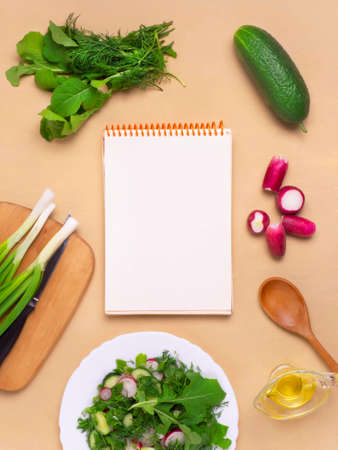 The concept of a healthy vegan diet. A clean notebook with fresh vegetables and herbs. The Concept Of Vegetarian Cooking. Flat lay.の写真素材