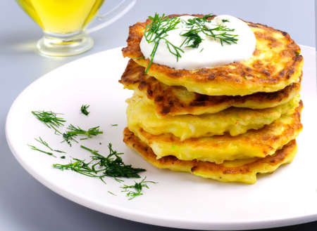 vegetable zucchini fritters on a plate closeup with dillの写真素材