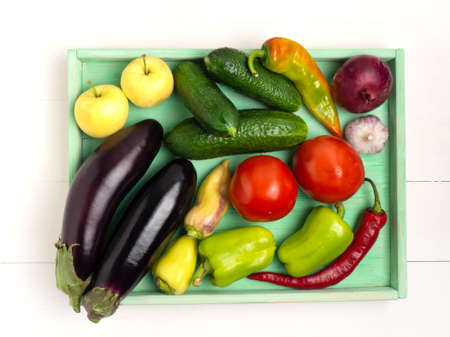 Tray with various vegetables on a white wooden backgroundの写真素材