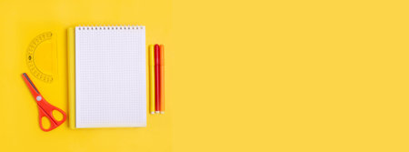 School supplies on an orange background. School concept, office supplies. A copy of this place.