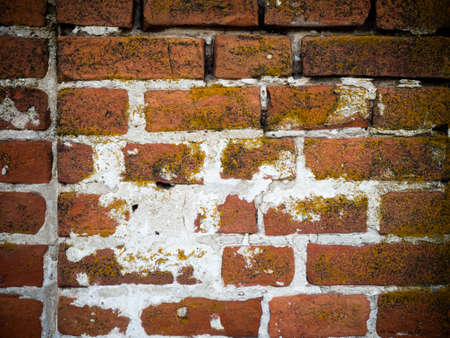 Background of old vintage dirty brick wall with peeling plaster, textureの写真素材