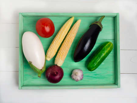 Tray with various vegetables on a white wooden backgroundの写真素材