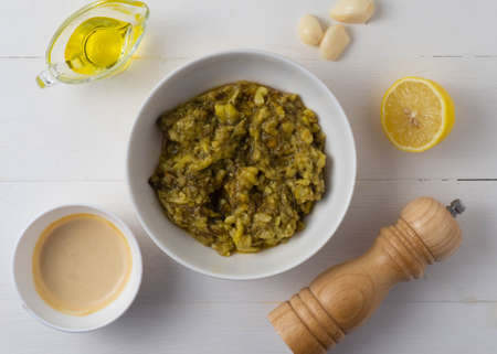 Middle Eastern cuisine-babaganush (eggplant caviar) from baked eggplant, garlic, tahini, lemon, olive oil, mint. Step-by-step recipe.の写真素材