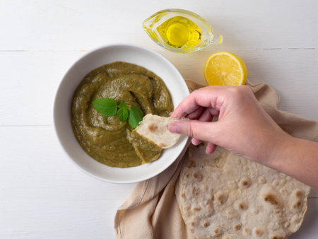 Middle Eastern cuisine-babaganush (eggplant caviar) from baked eggplant, garlic, tahini, lemon, olive oil, mint. Step-by-step recipe.の写真素材